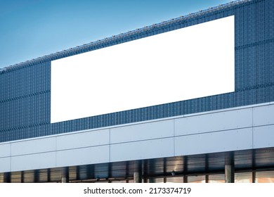 Mock up template. Big horizontal white blank signboard, advertising billboard on modern building wall outdoors