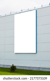 Mock Up Template. Big Vertical White Blank Signboard, Advertising Billboard On Modern Building Wall Outdoors