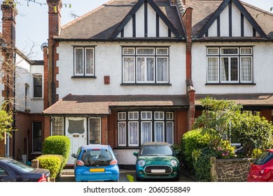 Mock Tudor terraced houses with driveways in London, England