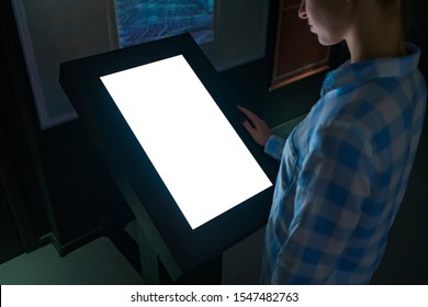 Mock Up, Copyspace, Template, Education, Future And Technology Concept - Woman Looking At White Blank Interactive Touchscreen Display Kiosk In Dark Room Of Modern Technology Museum - Close Up View