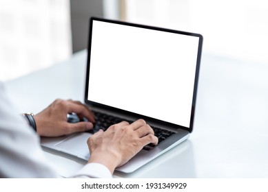 Mock Up. Man Using Laptop White Blank Screen Table At Office.