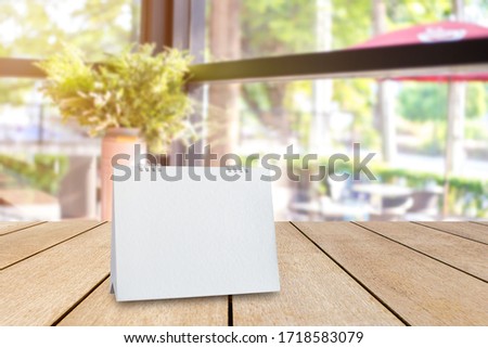 Mock up white acrylic frame posters pattern template blank menu put on old wood table in coffee shop and restaurant stand for your text of display your product.
