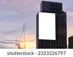 Mock up white background billboard on building, clipping path for Mockup. A large empty billboard on a city background in the middle of the sunset.