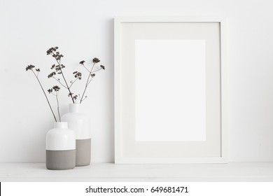 Mock Up White Frame And Dry Twigs In Vase On Book Shelf Or Desk. White Colors.
