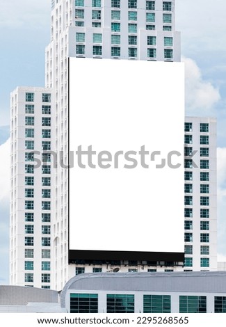 Mock up white large LED display vertical billboard on tower building .clipping path for mockup