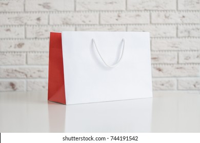 Mock Up Of White Paper Bag On The White Table, Blank Craft Package 