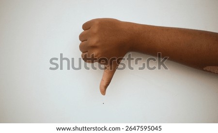 mocking the weak! the thumbs down hand symbol indicates weakness, defeat or inability
