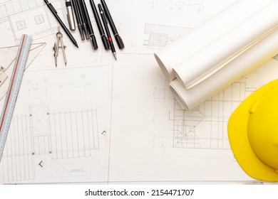 Mockup Of Architectural Concept, Drawing Tools And Engineer Drawing On Blueprint With Safety Helmet.