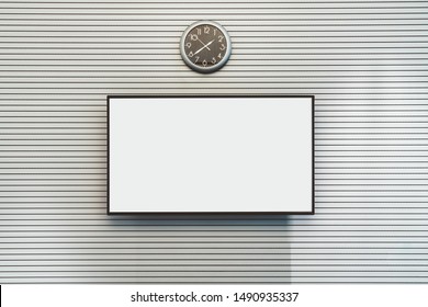 The Mockup Of A Big Empty LCD Screen Hanging On A Striped Wall Of An Office Meeting Room With A Watch Above; The Template Of A Blank Plasma TV Screen On The White Surface With Lines And A Wall Clock