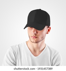 Mockup Of A Black Baseball Cap On A Guy's Head, Looking From Under A Visor, Front View, Empty Panama For Design Presentation. Sun Protection Headdress Template. Fashionable Sports Hat For Hip Hop, Rap