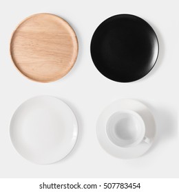 Mockup black dish, white dish, wooden plate and cup of coffee set isolated on white background. Copy space for text and logo. Clipping Path included on white background.