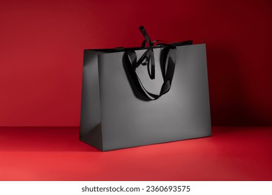 Mockup of a black paper bag with handles and bow ties