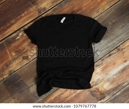 Mockup of blank black tshirt on rustic wood background 商業照片 © 