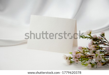 Mockup blank card, for Name place, Folded, greeting, invitation with wax flower on white background.