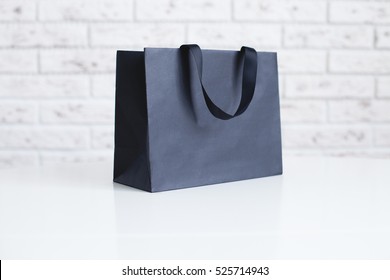 Mock-up Of Blank Craft Package, Mockup Of Black Paper Shopping Bag With Handles On The White Background