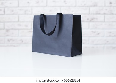Mock-up Of Blank Craft Package, Mockup Of Black Paper Shopping Bag With Handles On The White Background