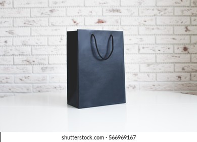 Mock-up Of Blank Craft Package, Mockup Of Black Paper Shopping Bag With Handles On The White Background