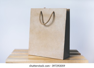 Mock-up Of Blank Craft Package, Mockup Of Brown Paper Shopping Bag With Handles On The White Background