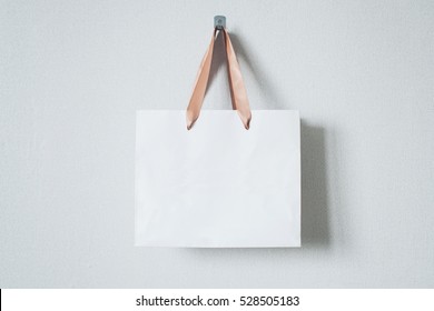 Mock-up of blank craft package, mockup of white paper shopping bag with handles on the neutral background - Shutterstock ID 528505183