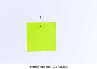 Mockup of a Blank Green Memo Paper with Copy Space Hanging on a Fishing Hook Against the White Background. Reminder or To Do List. Sticky Note Template - Shutterstock ID 2157280881