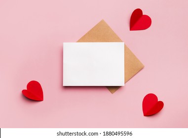 Mockup blank greeting card for valentines day. Composition with red hearts for Valentine's Day on a pale pink background. Flat lay. Love and relationships concept. - Shutterstock ID 1880495596