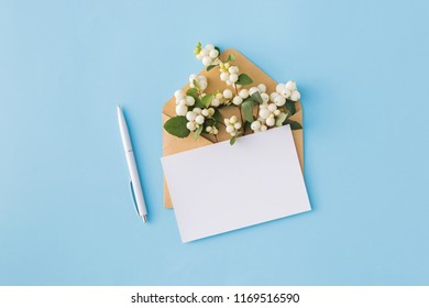 Mockup Blank Paper Card And Envelope On A Blue Background. Flat Lay, Top View