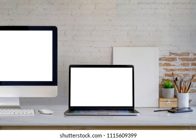 Mockup blank screen desktop and laptop computer on desk. workspace front view