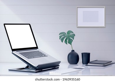 Mockup blank screen laptop computer on wooden stand with keyboard and mouse on white top table.
