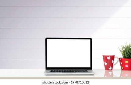 Mockup Blank Screen Laptop Computer And Red Mug On White Table With Copy Space.