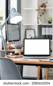 Mockup Blank Screen Laptop Computer On Wooden Table In Modern Room. Creative Workspace With Laptop. Blank Screen Laptop For Product Display. Vertical View.