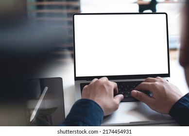 mockup, blank screen laptop computer. Business man working on laptop computer on table at office. mock up for website design and digital marketing, over shoulder, rear view