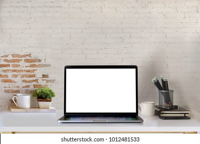 Mockup Blank Screen Laptop On Desk. Workspace With Laptop And Office Supplies.