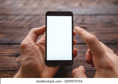 Mockup of blank screen of smartphone, male hand holding smartphone with template screen with area for your logo or design