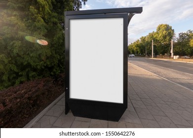 Mockup Of The Blank White Street City Outdoor Advertising Vertical Billboard In Black Frame On Sidewalk Bus Stop Shelter