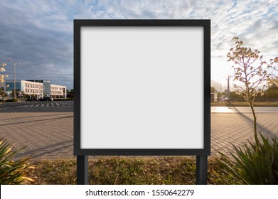 Mockup Of The Blank White Street City Outdoor Advertising Square Billboard In Black Frame On Sidewalk