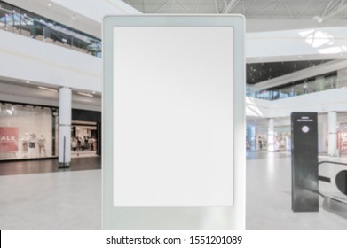 Mockup Of Blank White Vertical Indoor Advertising Poster Stand With White Frame In Shopping Centre Or Mall