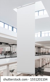 Mockup of blank white vertical indoor advertising flag hanging in shopping centre or mall