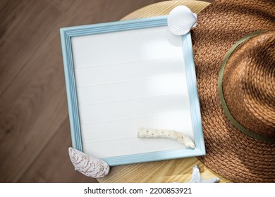 Mockup Blue Frame With Seashell ,hat Decor On Side Table