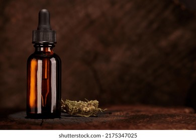 Mock-up Of Bottle With Dropper, CBD Oil For Product Presentation. Shot From Eye Level, In Front. Old Wooden Top. Alternative Medicine, Conceptual Image.