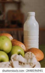 mockup bottle with kefir, milk and green apples in a wooden kitchen. High quality photo