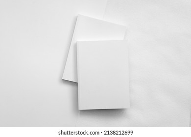 Mockup Of Brochure With Fold. Blank Mock Up Of Booklet, Menu And Book. White Paper Of Magazine. Mockup Of Leaflet. Template Of Twofold Pamphlet Isolated On White Background