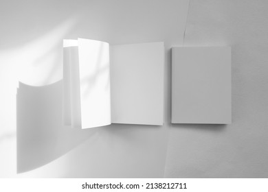 Mockup Of Brochure With Fold. Blank Mock Up Of Booklet, Menu And Book. White Paper Of Magazine. Mockup Of Leaflet. Template Of Twofold Pamphlet Isolated On White Background With Shadows.