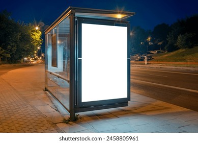 Mockup Of Bus Stop Advertising Billboard On A City Street At Night. Outdoor Poster Lightbox With Car Light Trails In The Background