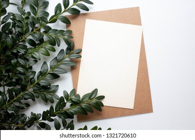 mockup card with plants. invitation card with environment and details Mockup with postcard and flowers on white background.