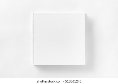 Mockup of closed blank square book at white textured paper background. - Shutterstock ID 518861245