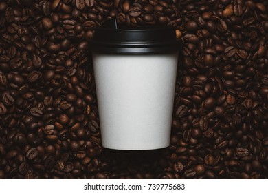 Mockup of coffee beans with white paper cup.
