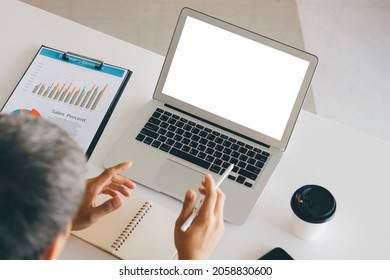 Mockup Copy Space Computer Notebook Laptop Concept, a man's hand using a laptop on internet websites at the office, keyboards on laptop computer with blank copy screen for your advertising content.