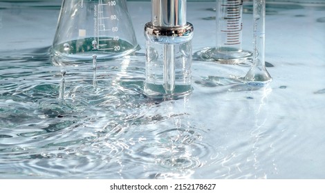 Mockup Of Cosmetic Glass Bottle With Pipette And Serum On Water Surface. Science Cosmetic Laboratory Concept. Cosmetology Research