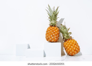 Mockup cosmetics skin care product presentation scene made with empty white podiums and juicy pineapples. Studio photography. - Powered by Shutterstock