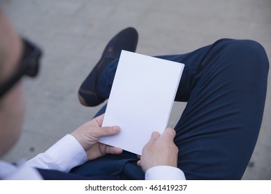 Mockup Cover Magazine, Catalog, Book. Man Reading A Blank Magazine, Catalog, Book On The Bench.